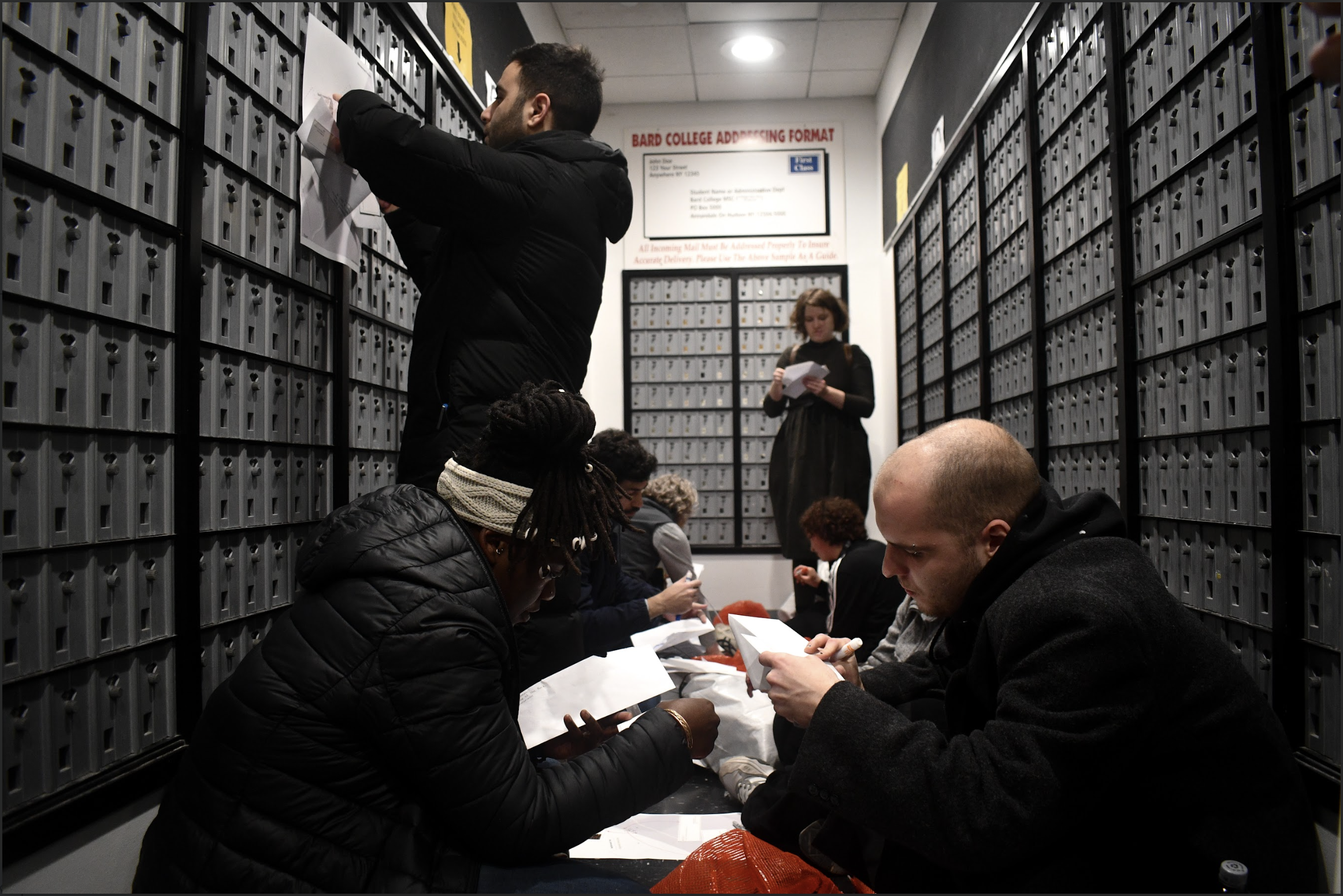 Participants sorting undelivered mail in a post office installation
